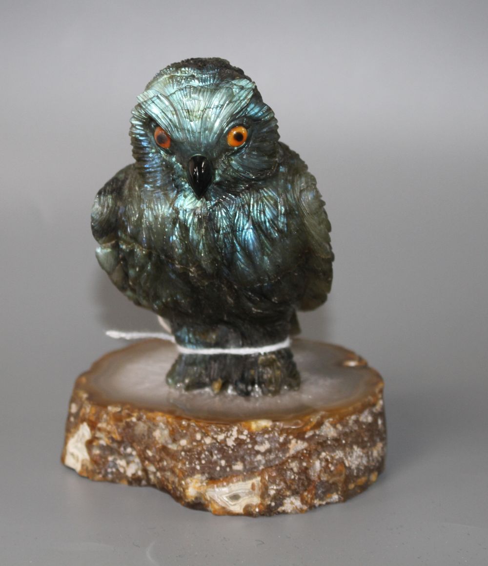 A carved labradorite model of an owl on an agate base, height 12.8cm.